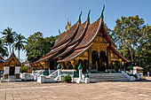 Wat Xieng Thong temple in Luang Prabang, Laos.  A view of the 'sim' with the large sweeping roof. 